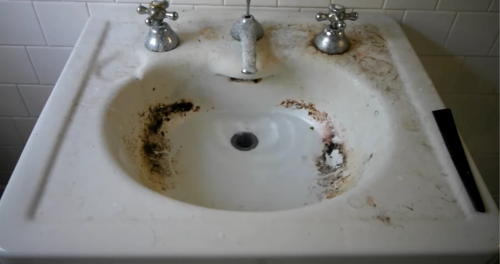 Drain snaking bathroom hair and soap scum buildup