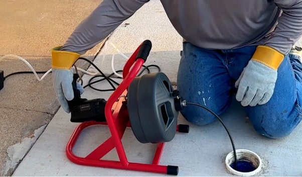 How a drain snake flexible cable works to clear clogged pipe